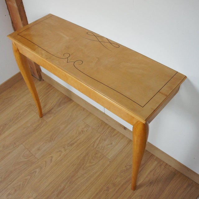 An Art Deco console table. Satinwood veneered with satinwood inlay. Dimensions: H 74cm W 93cm D 32cm Origin: French Date:...