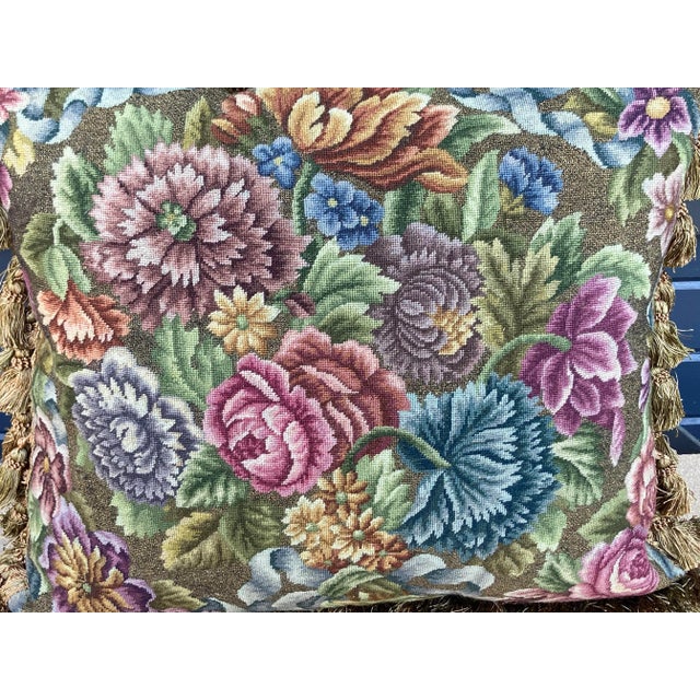 An exceptional needlepoint pillow hand worked with very fine metallic thread, featuring a vibrant floral bouquet,...
