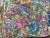 An exceptional needlepoint pillow hand worked with very fine metallic thread, featuring a vibrant floral bouquet,...