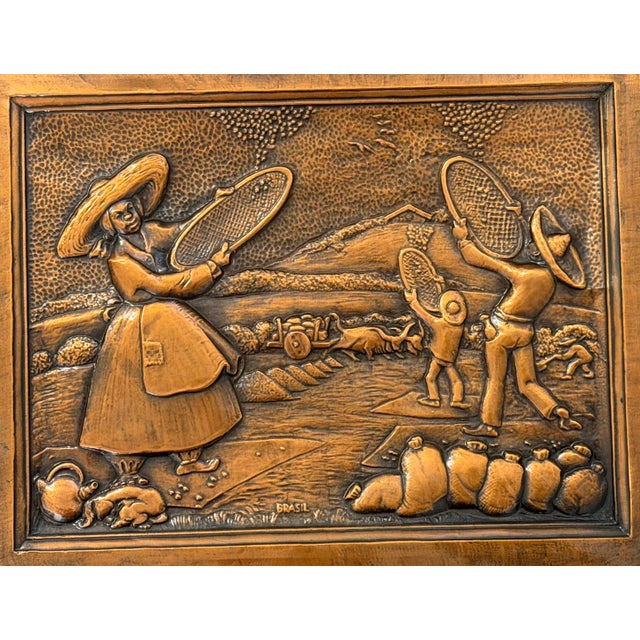 Vintage Brazilian metal relief wall art depicting farm workers in a rural landscape. The detailed scene shows figures in...
