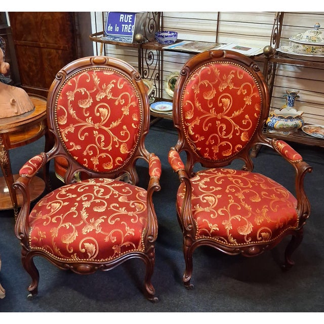 A pair of mahogany armchairs, dating from the 19th century, featuring elegant, flowing lines in the Louis-Philippe style....