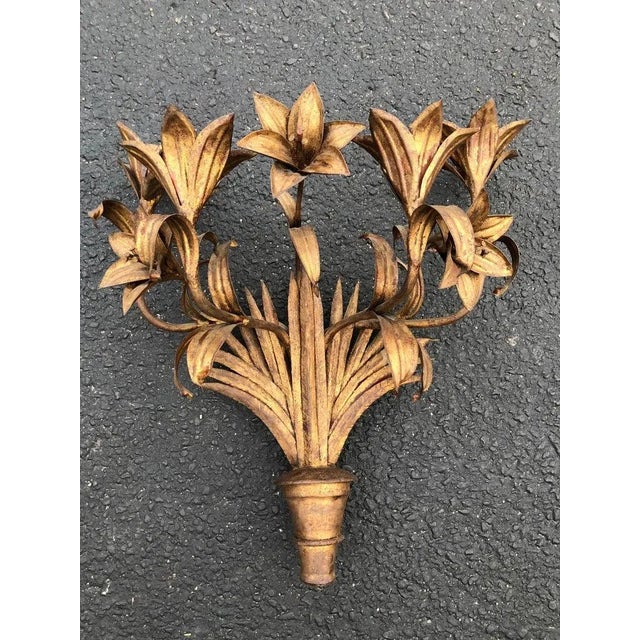 Large Italian Gilt Iron Floral Wall Sconce. Adorned with five elaborate Tiger Lilly flowers and four candle holders. It...