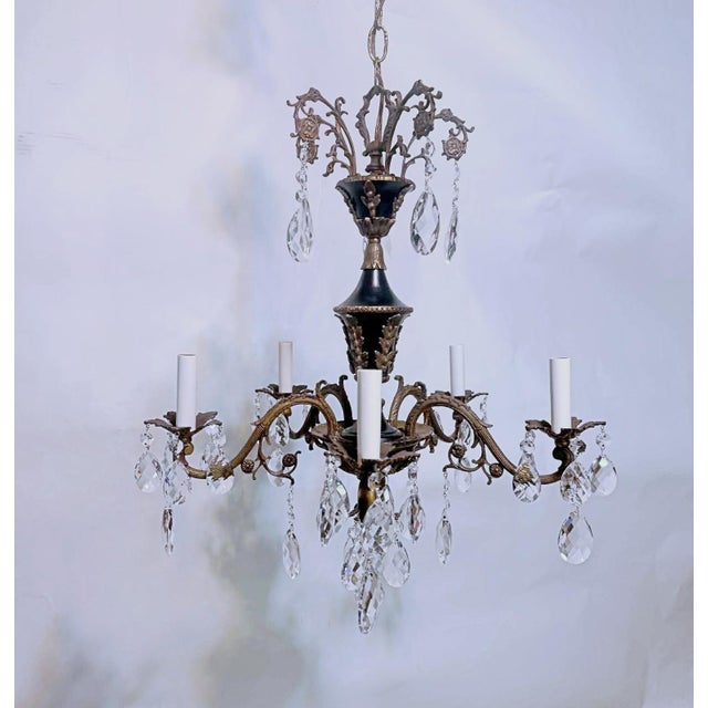 This is a Spanish style bronze chandelier with ornate designed frame, black details that highlight its beauty.Decorated...