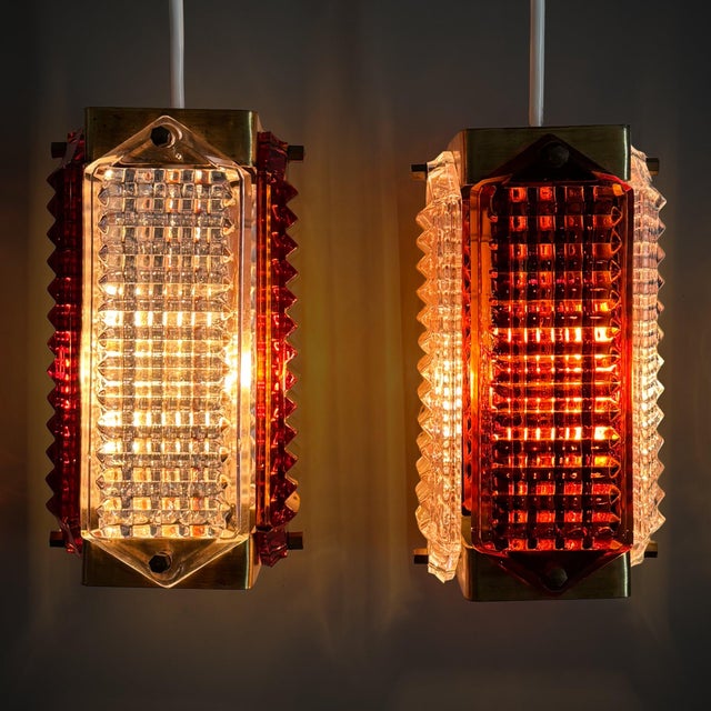 A pair of pendant lamps designed by Wiktor Berndt for the Swedish glassworks Flygsfors during the 1960s. Each lamp is...
