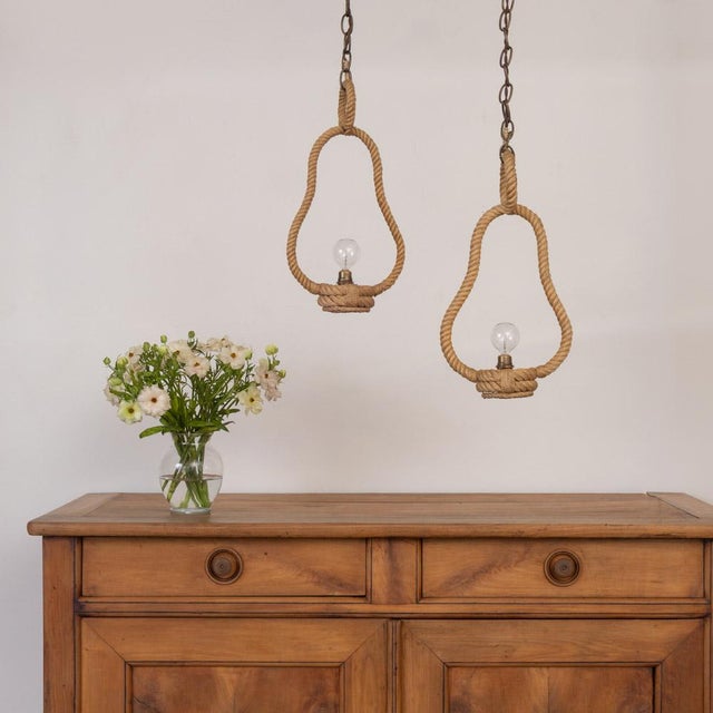 Beautiful pair of rope pendant lights by Adrien Audoux and Frida Minet from France, 1960s. Curved twisted rope bell frame...