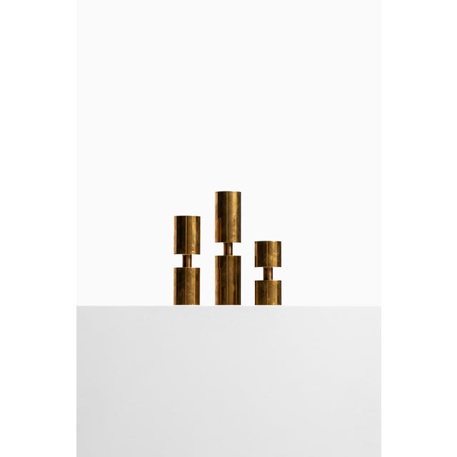 - Set of 3 candleholders - Designed by Thelma Zoéga - Produced in Sweden - Made in brass - From the 1970s - Height range:...