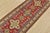 A tribal Caucasian Kazak runner hand-knotted with fine wool on a cotton foundation. This rug features geometric motifs set...