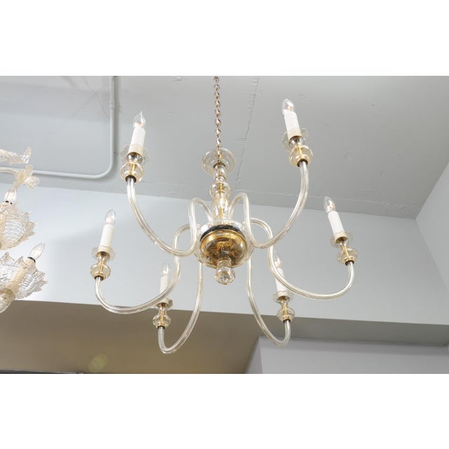 A refined six-light Venetian glass chandelier accented with all original aged, polished brass hardware. Clean lines and...
