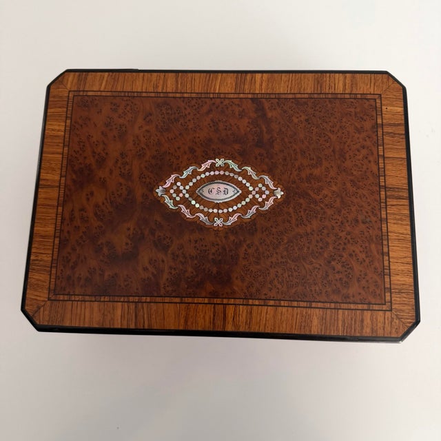 Exotic wood, marquetry, mother of pearl inlay and a velvet divided jewelry tray inside makes this box extra special. No...