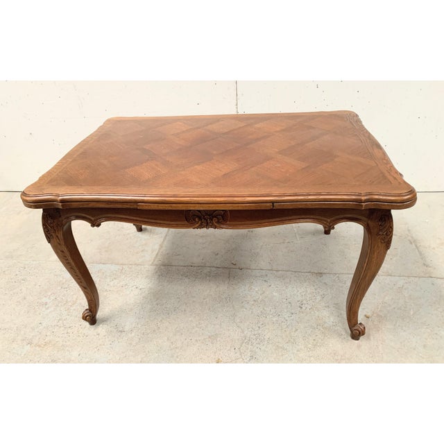 Regency style solid oak table scroll base with carved top top and extensions veneered in versailles parquet good condition...