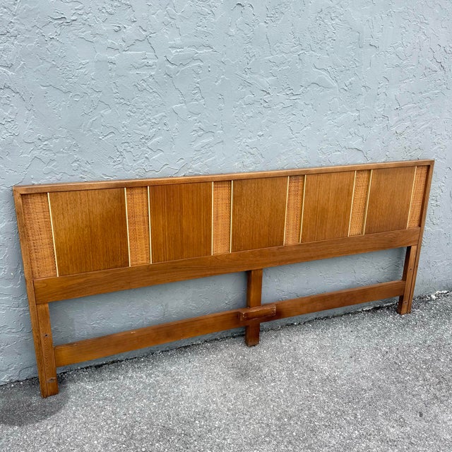 A refined mid century modern king size headboard crafted in warm teak, featuring a rhythmic composition of paneled wood...