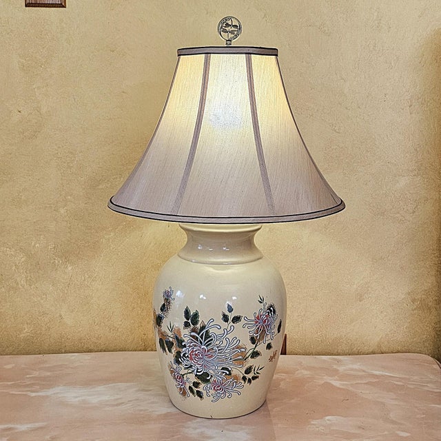 Vintage American ceramic table lamp featuring a cream glazed porcelain body with hand-painted chrysanthemum blossoms,...