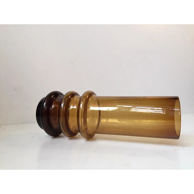 This yellow smoked glass vase that is partially hooped was designed by Bo Bergström and manufactured by Aseda Glasbruk in...