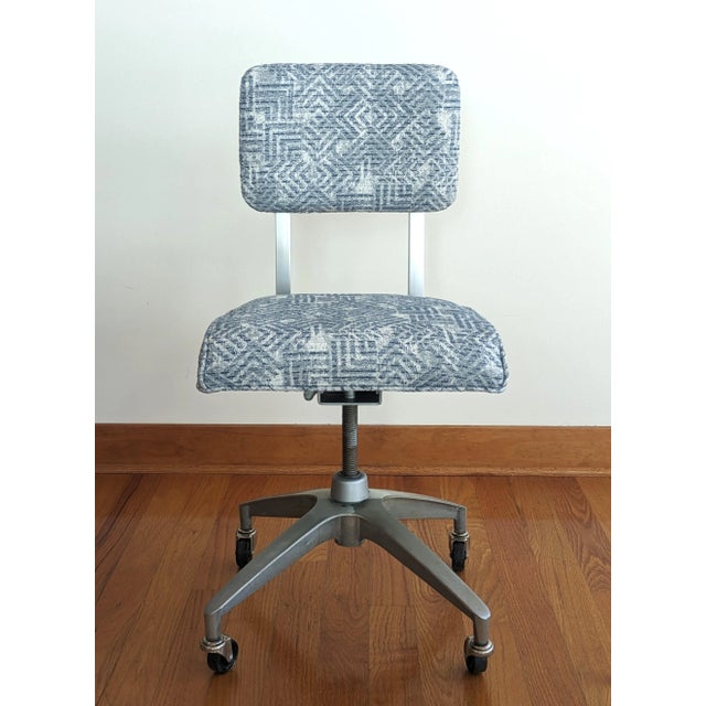 A blue vintage office chair by Metalstand. The mid-century desk chair has been reupholstered using a blue and white...