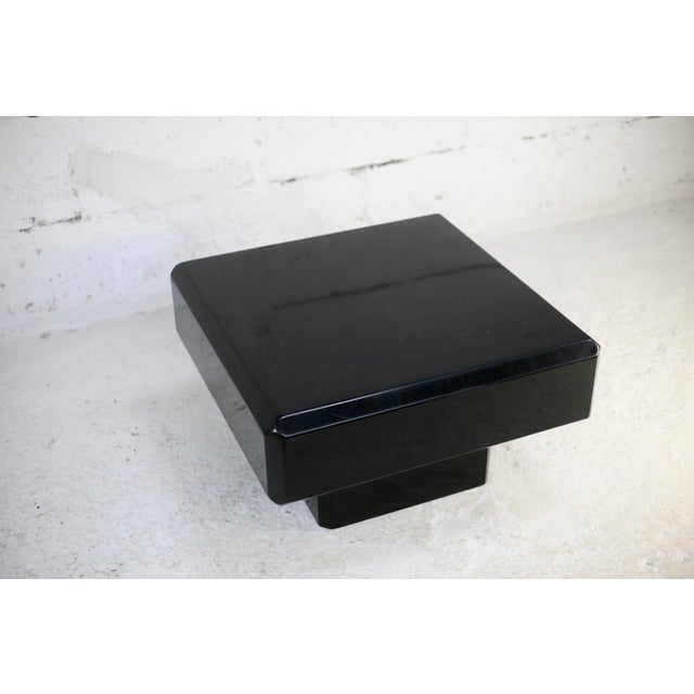 Black lacquered wood coffee table. Oblique sides. France, circa 1970. Very beautiful design. Numerous lacquer stripes on...