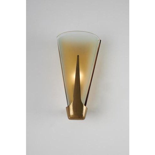 Wall sconce with a brass frame and diffusers in various colors, made of curved and etched glass. Manufactured by fontana...