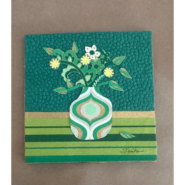 A charming original floral composition featuring a decorative vase filled with fanciful blossoms, curling stems, and...
