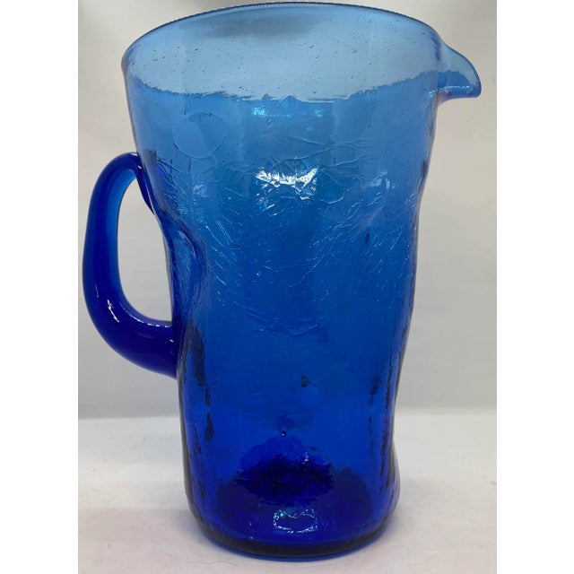 Beautiful Midcentury Cobalt Blue Crackle Glass Pitcher! It was made by the Bischoff Glass Company which was located in...