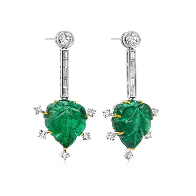 These earrings feature 11ct of richly verdant emeralds, each one hand‑carved into an elegant leaf motif — a beautiful nod...