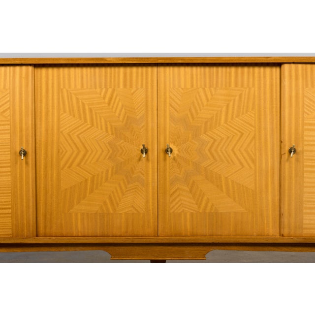 French Art Deco sideboard dating to the 1940s, sourced in Provence. The piece is veneered in blond sycamore maple and...
