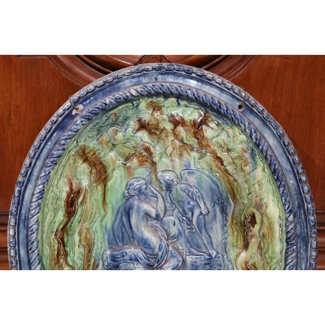 Decorate a wall or display shelf with this colorful 19th-century glazed terracotta plate. Sculpted in Beaune, France circa...