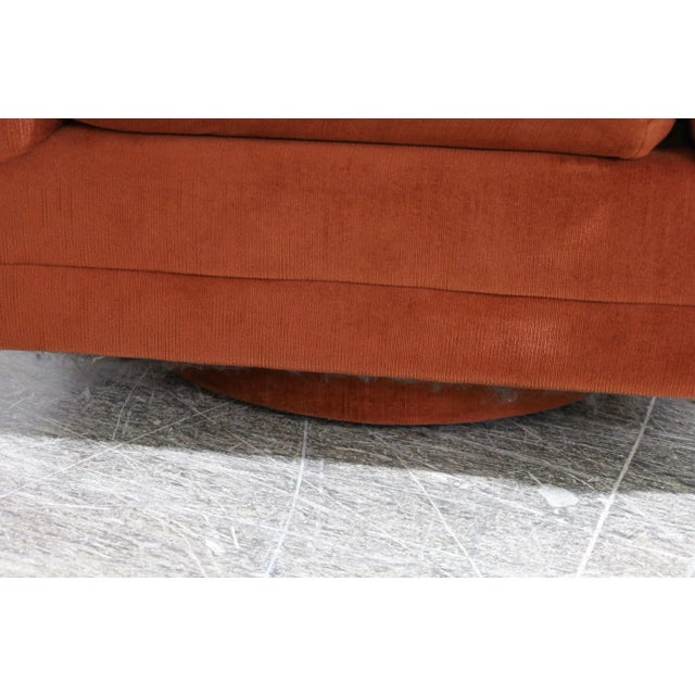 A great Pair, Channel Back Swivel Chairs probably from the 1970’s in burnt orange upholstery on plinth base.