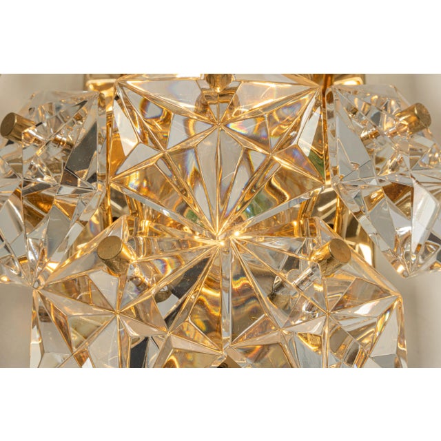 A stunning pair of golden sconces with crystal glasses, made by kinkeldey, germany, circa 1970-1979. It’s composed of...