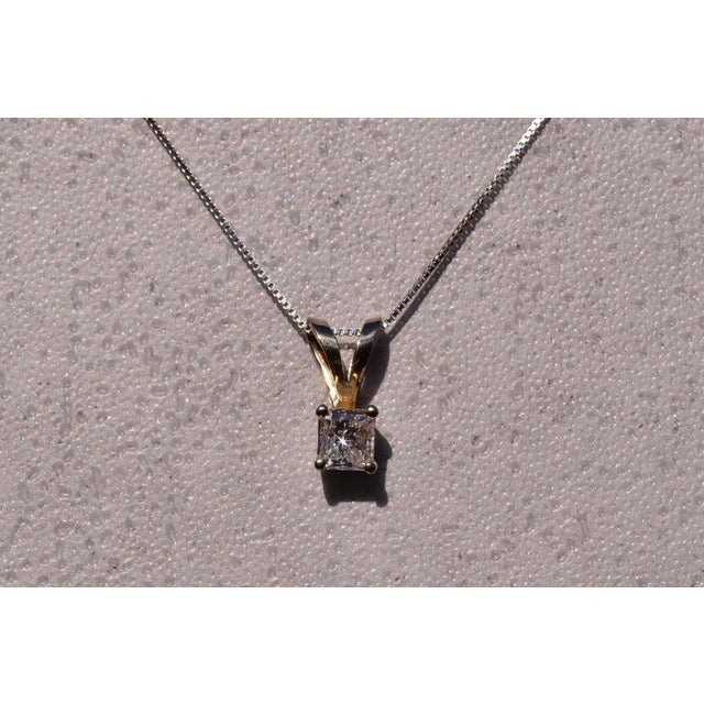 The 28th Street: Solitaire Pendant with Princess Cut Natural Diamond. The pendant features a 0.53 carat square modified...