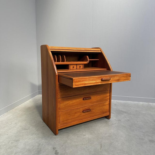 Danish design secretary in high-quality solid teak with a tambour door, writing board that can be folded up and various...