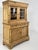 19th-20th century pine and glass sideboard/display cabinet, composed of two sections: The upper section features a glass...