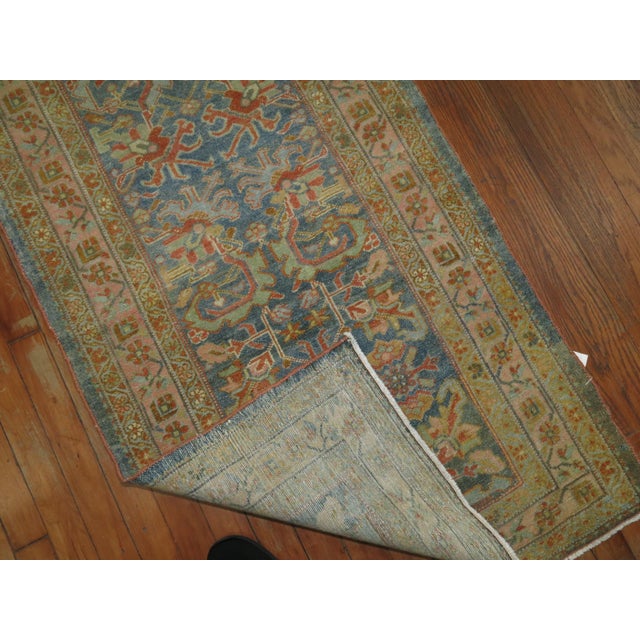 An early 20th century Persian Malayer Rug with a blue background and accents in pinks and red accents Details rug no....
