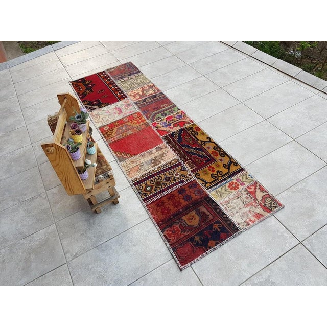 This is a vintage Turkish Oushak rug from the Mid 20th Century. The piece was hand-knotted.