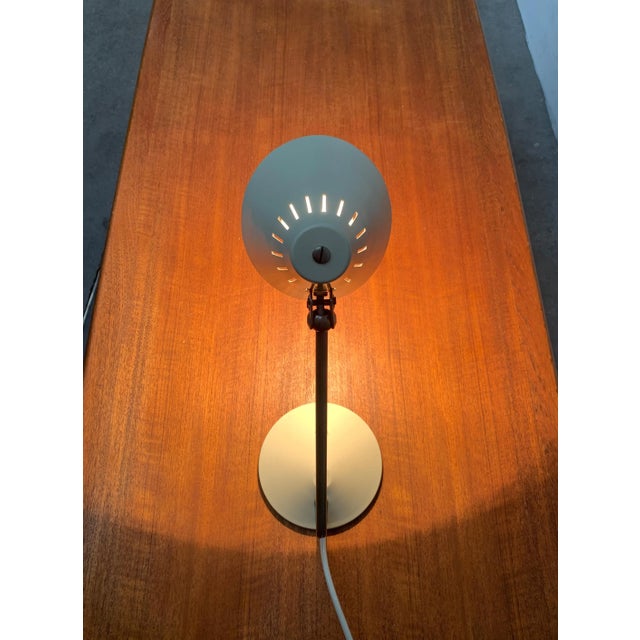 Mid Century table lamp. The screen of the luminaire is cone-shaped. He can be aligned with a joint. Striking is the angled...