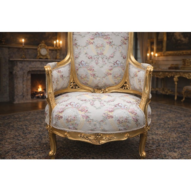 A refined pair of 1970 French Louis XVI–style bergère chairs, crafted in solid beechwood and finished in a warm antique...