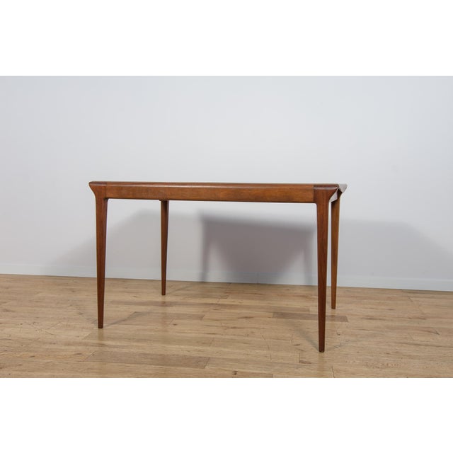 Rectangular extending dining table manufactured by the British furniture maker McIntosh in the 1960s, representing an...