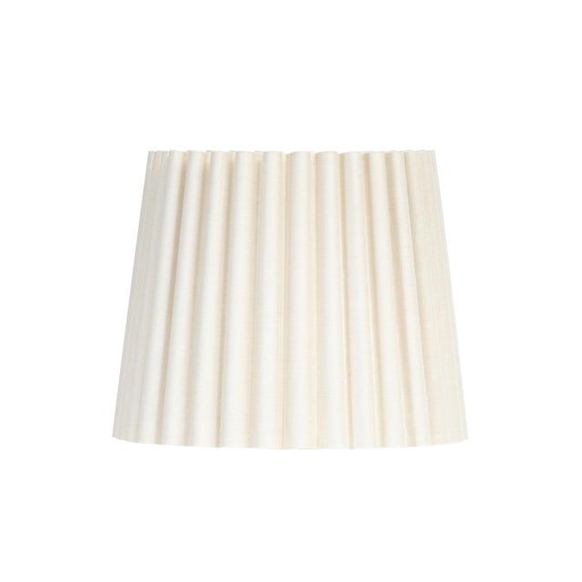 The Oyster Wave Pleat Alternate Shade is crafted from natural linen in a soft, warm hue, shaped in a structured, hard-...