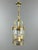 An elegant cylindrical hanging lantern in bronze and glass. The finely crafted frame features openwork decoration and...