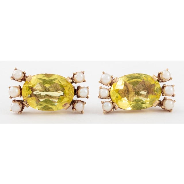 14K yellow gold clip earrings, featuring two oval brilliant citrines weighing a total of approx. 22.00 carats, further...