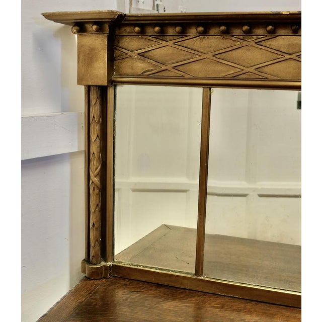 Regency Triple Plate Gilt Mirror or Over Mantle The Regency carved Frame is a rectangular shape, it has columns at either...