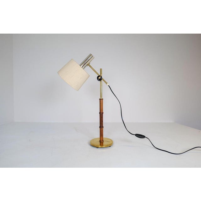 This lamp was made in Sweden at Falkenbergs Belysning. It has an adjustable height and angle arm, and is made in brass,...
