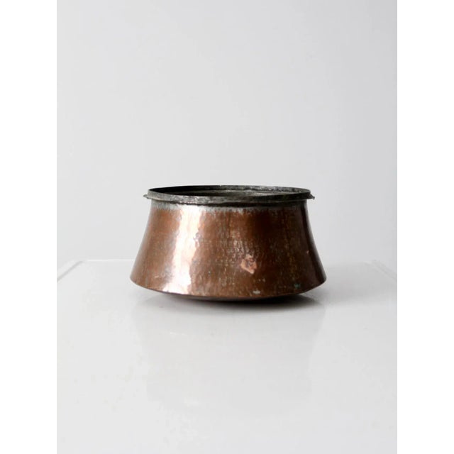 Antique hammered copper cauldron with a rounded bottom, tapered sides, and a rolled rimmed top lip. Hand-formed from heavy...