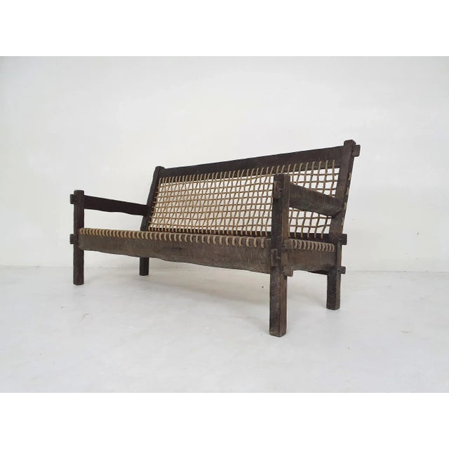 Beautifuly carved wooden sofa with rope seating and back.