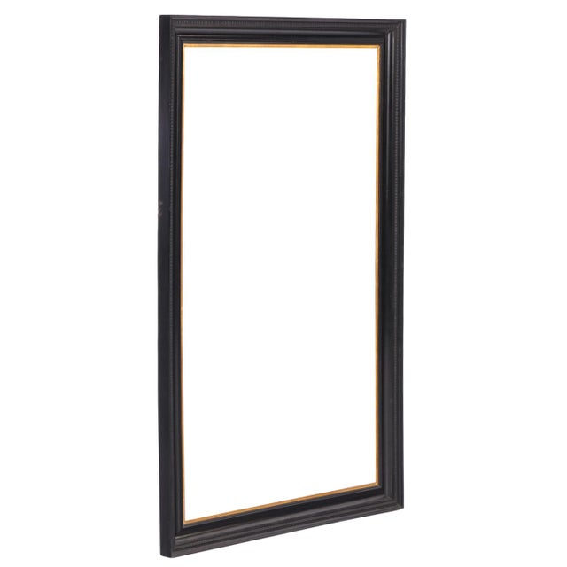 An elegant Italian frame featuring a substantial molded ebonized outer surround enriched by a finely crafted giltwood...