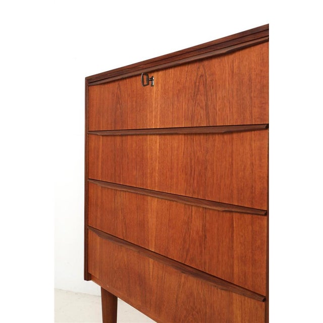 1960s-1970s, Denmark. Teak (veneer and solid wood). Comes with original key. Overall dimensions approx.: 78 x 77 x 40 cm...