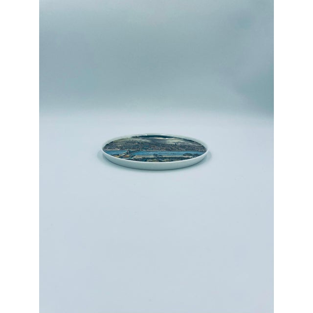 A decorative wall plate by German artist Kurt Hammer, made of high-quality porcelain. The plate is decorated with a...
