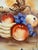 Vintage Japanese hand-painted porcelain fruit bowl featuring peaches, grapes, and bananas, accented with gilt scrollwork,...