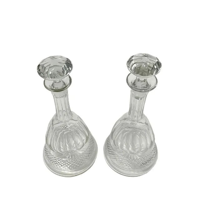 2 crystal ship decanters in bell shape. Bell shaped decanters, diamond cut and star cut shape bottom 1 Stop has a saw cut....