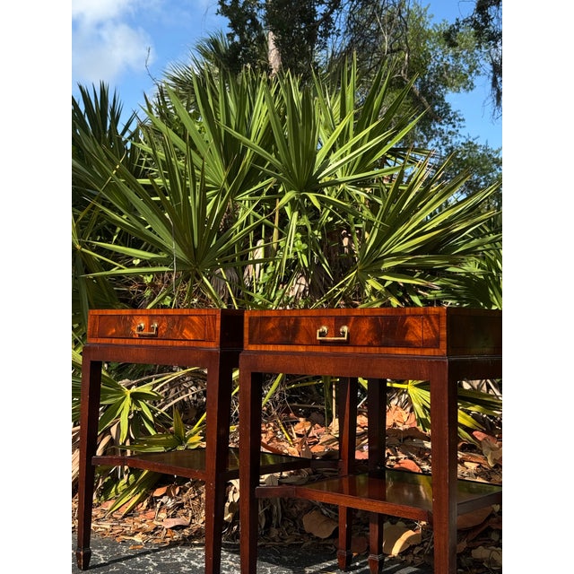 A handsome pair of 1940s mahogany end tables showcasing timeless craftsmanship, elegant proportions, and beautiful figured...