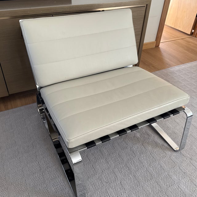Authentic Minotti Delaunay lounge chair upholstered in light neutral leather with a polished chrome frame. Clean modern...