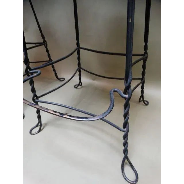 A pair of super bar stools, French, and wrought iron, wood seats and arm rests. Intricately designed. Each stool 20 1/4"...